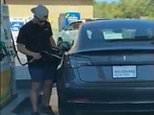 Hilarious moment driver tries to fill his Tesla at a gas station before realising it is ELECTRIC