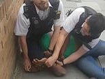 Officer is suspended after shocking footage showed handcuffed black man yelling ‘get off my neck’