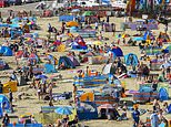 Calm before the storm! Britain struggles through barmy night after 100F heat but rain is on the way