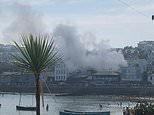 Beachgoer is left with serious burns as blaze tears through restaurant in Cornwall 