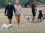 Ant McPartlin and Anne-Marie Corbett get caught in the rain as they enjoy windy walk with their dogs