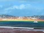 Rare flat rainbow beams across sea in Devon
