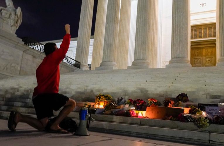 Mourners are holding a candlelight vigil outside of the Supreme Court