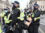 Topless Extinction Rebellion activists padlock themselves to the gates of Parliament