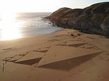 Sand artist makes triangle-themed beach design as his 500th large-scale artwork