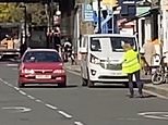London traffic: Mystery placard-waving woman warns unwitting drivers of £130 fine