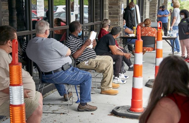 Jobless claims fall to 751,000, but new infections a threat
