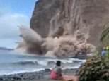 Terrifying moment a huge chunk of cliff collapses onto a Spanish beach
