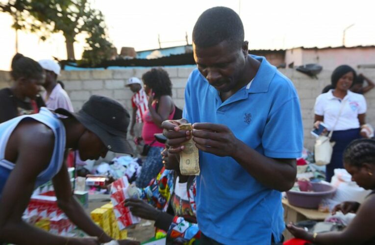 Zimbabweans mend shabby dollar notes amid economic crisis