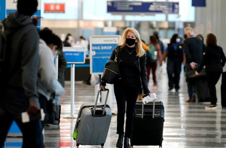Holiday air travel surges despite dire health warnings