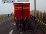 Footage shows group of migrants in Calais armed with projectiles terrorising drivers 