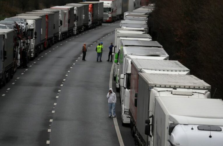 Isolation of UK eases but backlog could take days to clear