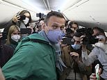 Putin critic Alexei Navalny faces imminent arrest as he lands back in Moscow