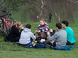 Parks are packed as people bask in the winter sun and even enjoy PICNICS