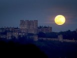 Breathtaking Snow Moon glows burning orange as it lights up the night sky