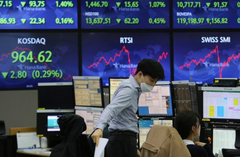 Stocks end a wobbly day with mixed results; yields rise
