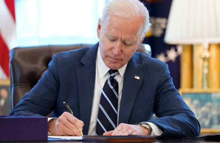 The President signs his rescue bill into law. This comes a day earlier than expected as he wanted to sign it as soon as possible, the White House says.