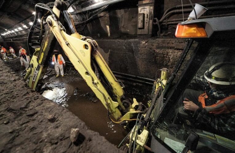 In a leaky underwater rail tunnel, workers race against time
