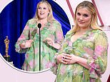 Oscars 2021: Emerald Fennell shows off baby bump in billowing gown as she walks the pink carpet