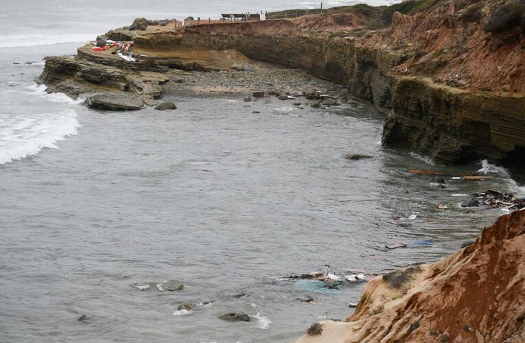 The suspected smuggling vessel hit a reef and broke up, an official says. More than 20 people have been hospitalized.