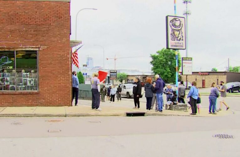 Demonstrators gather at shop that offered ‘not vaccinated’ Star of David badges