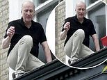 Ade Edmondson, 64, traps himself on a LEDGE while cleaning his windows