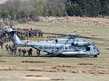 US Marines pile aboard twin-propeller Osprey and Sea Stallion choppers