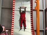 Moment acrophobic man squeals in panic as he is hoisted to the top of a 32ft slide