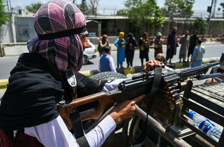 Images of uncovered women are painted over in Kabul as militants celebrate victory