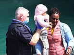 More very young children arrive on migrant boats while group of 40 young men come ashore