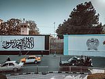 Taliban flag is seen painted on the walls outside the entrance of the former US embassy in Kabul