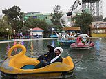 Afghan men smile in pedal boats in Herat as women continue to be oppressed under Taliban 
