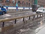 Tower Bridge is FLOODED: Rain causes travel chaos in London with roads and Tube stations underwater