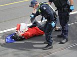 Policemen douse an elderly woman with pepper spray during Melbourne’s anti-lockdown protests