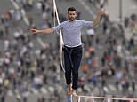 French daredevil crosses Seine in Paris on tightrope 200ft above the ground from Eiffel Tower 