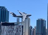 Heartstopping moment an RAAF C-17 cargo jet weaves through skyscrapers in Brisbane’s CBD