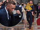 Conor McGregor carries his daughter during the christening of his son Rían at The Vatican in Rome