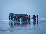 Flotilla of migrants in giant inflatable boats leaves coast near Calais