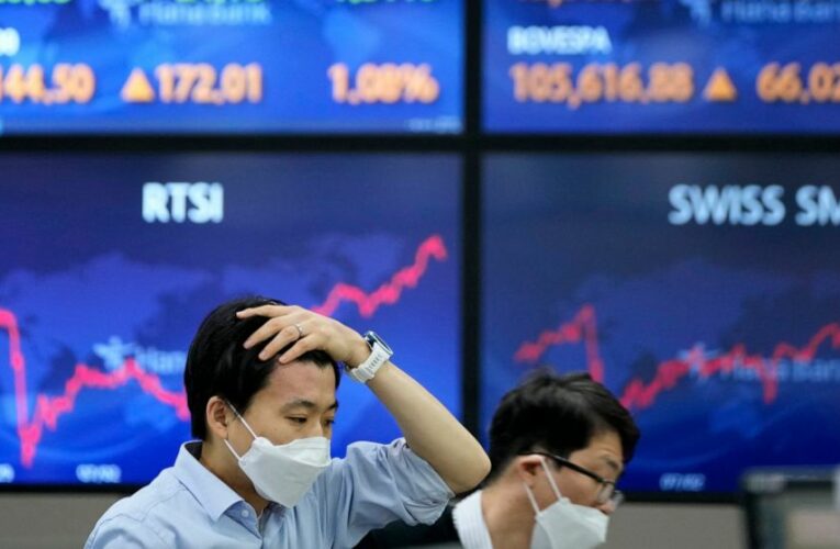 Asian shares mostly lower after fresh Wall St records