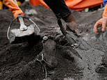 Rescuers dig out body of boy, 13, from the piles of ash left by Indonesian volcano