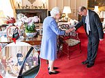 Queen reveals unseen photo cuddling with Philip and five great-grandchildren