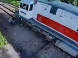 Family dodges speeding train after their motorbike gets stuck on tracks in Indonesia [VIDEO]