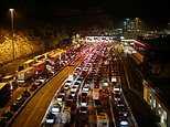 Britons queue for miles to try and get into France before ban on all tourists began at midnight 