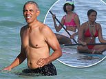 Barack Obama takes a dip in Hawaii, as daughters Sasha and Malia hit the water on paddleboards