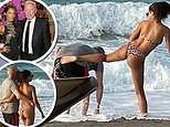 Boris Becker gets a playful kick from his lover as they stroll along Dubai beach