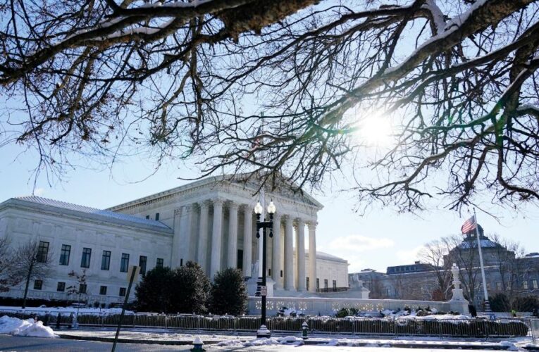 The court blocks Biden’s nationwide vaccine and testing mandate for large businesses but allows one for health care workers to take effect