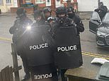 Armed father barricaded in home with son, eight, posts photos of police outside during two-day siege