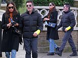 Simon Cowell wears his broken arm in a cast as he steps out with his fiancé Lauren Silverman