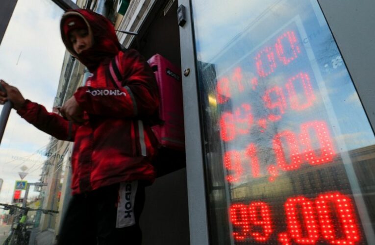 Ruble plummets as sanctions bite, sending Russians to banks