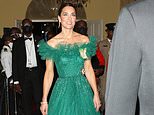 Kate glitters in jewels lent to her by the Queen as she and William arrive for black-tie banquet